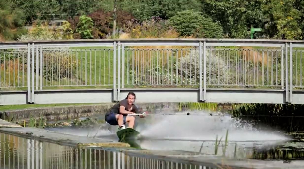 Action shot of wakeboarder going under Art Pavilion Bridge