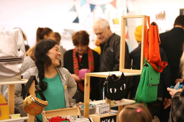 People examine crafts at the Art Fair