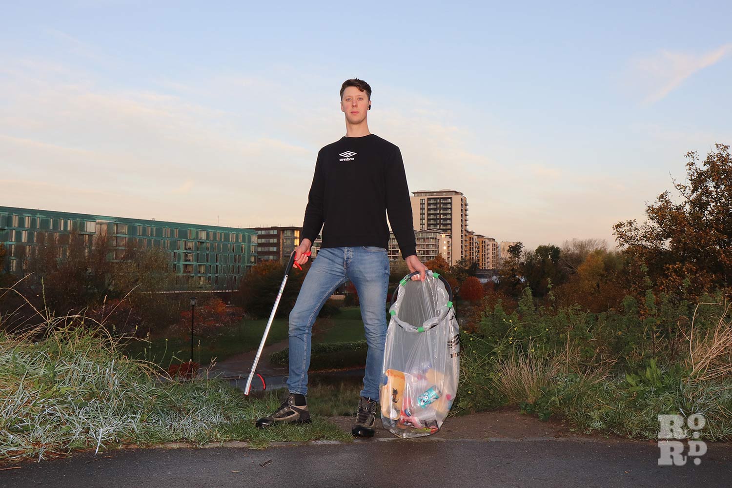 Ian standing atop Moel Mile End litter pick and bin bag in hand