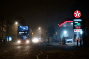 The 277 bus passes the GRove Road Texaco at night