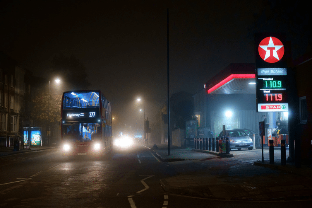 The 277 bus passes the GRove Road Texaco at night